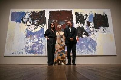 Director of the Tate Modern, Maria Balshaw, stands in front of the donated triptych by Joan Mitchell flanked by US-Argentinian businessman Jorge M. Perez and his wife Darlene Perez