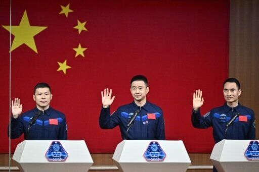 Astronauts for China’s Shenzhou-20 space mission (L-R) Wang Jie, Chen Dong and Chen Zhongrui wave during a press conference a day before the launch of the mission