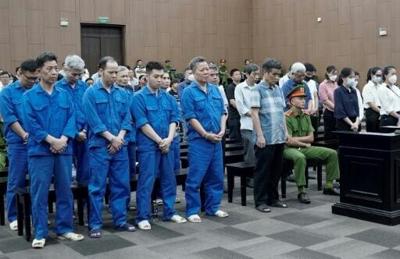 Defendants stand during their trial for illegal exploitation and exports of rare earths at the People's Court in Hanoi on May 21, 2025