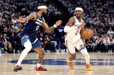 Oklahoma City's Shai Gilgeous-Alexander, right, drives to the basket against Minnesota's Nickeil Alexander-Walker in the Thunder's NBA playoff victory over Minnesota